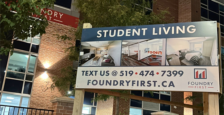 Photo of a sign outside the Foundry First building advertising student living in the building.
