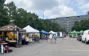 Photo of several vendors at the outdoor Masonville Market