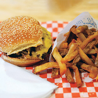 A photo of a burger and fries from Beach Boy Burger