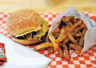 A photo of a burger and fries from Beach Boy Burger